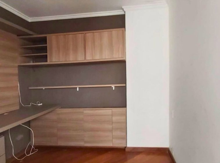 a room with a desk and shelves