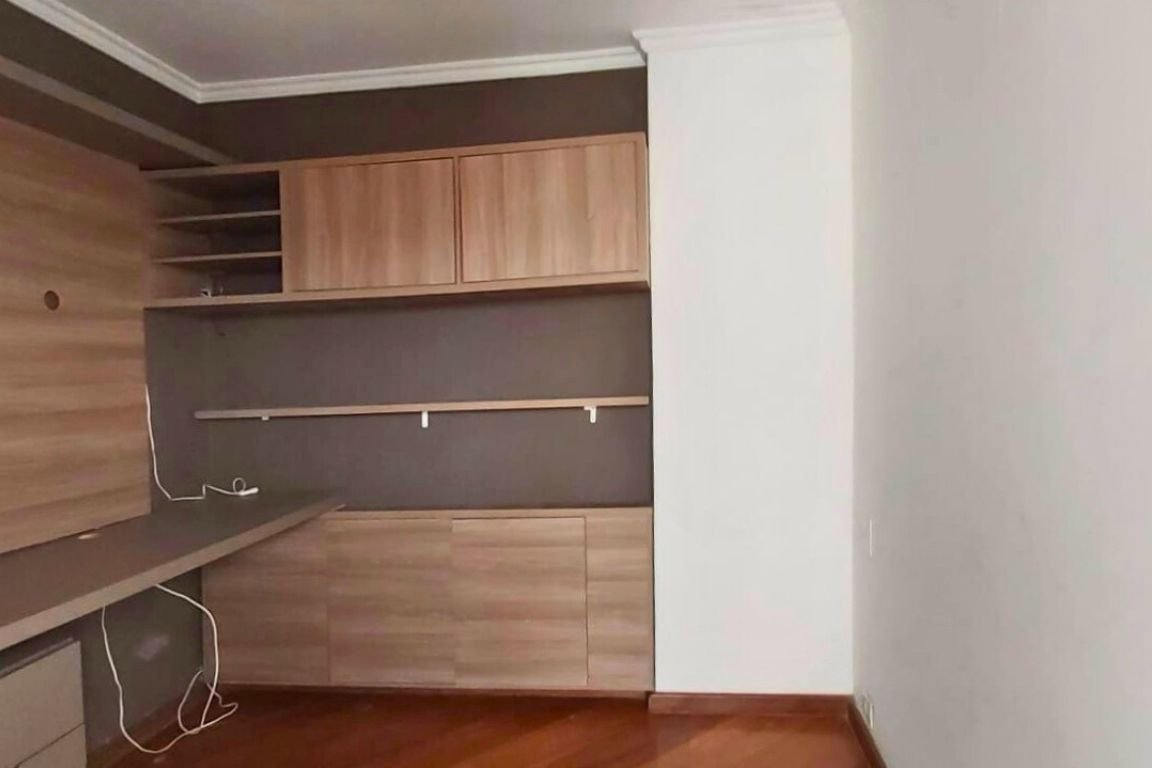 a room with a desk and shelves